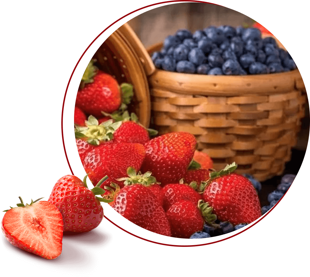 A close up of strawberries and blueberries in front of a basket