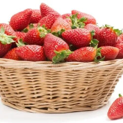 A basket of strawberries on top of the table.